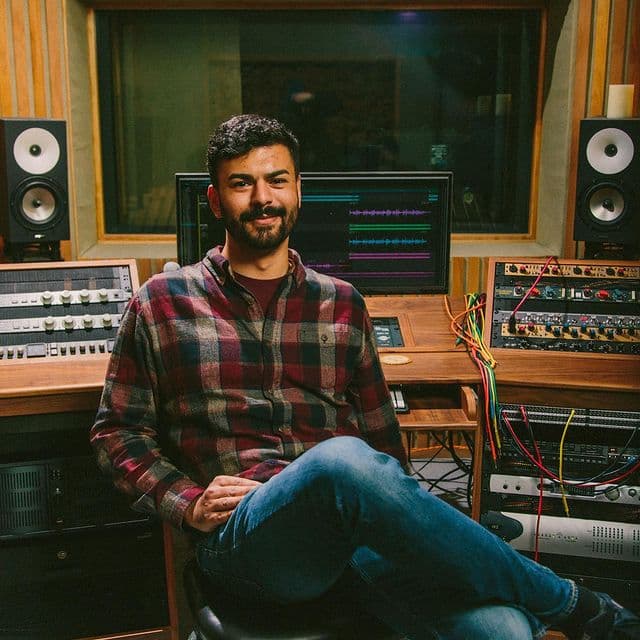 Picture of Dryw Owens inside his music studio